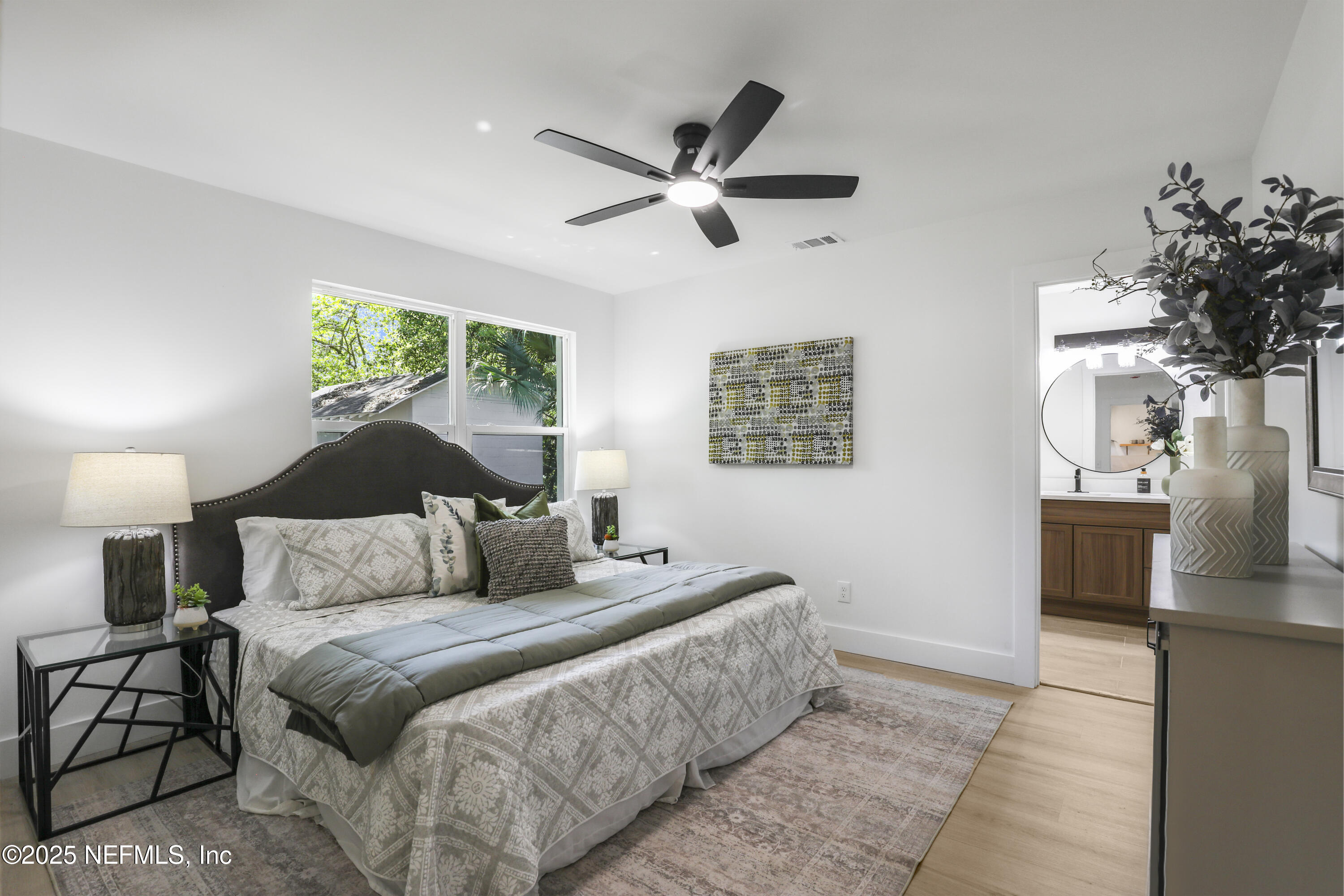 4630 Homestead Road Jacksonville, FL 32210 - Photo 24 of 45 a bedroom with a large bed and a chandelier