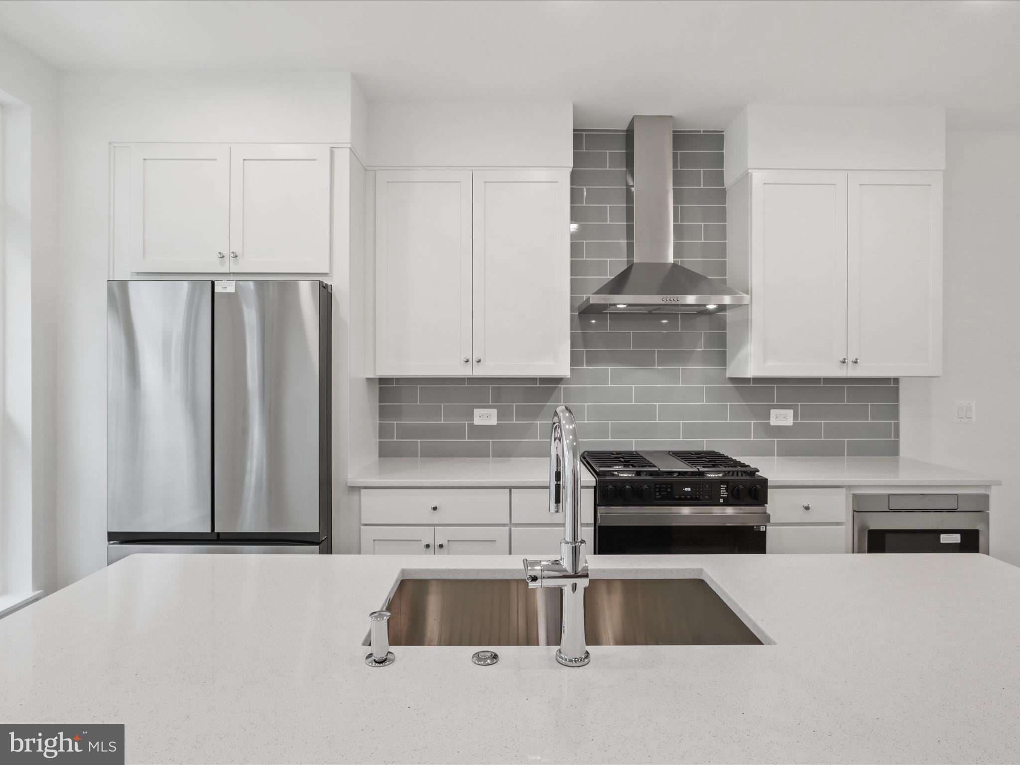 2064 Tysons Ridgeline Road Falls Church, VA 22043 - Photo 12 of 43 a kitchen with granite countertop a refrigerator and a stove top oven