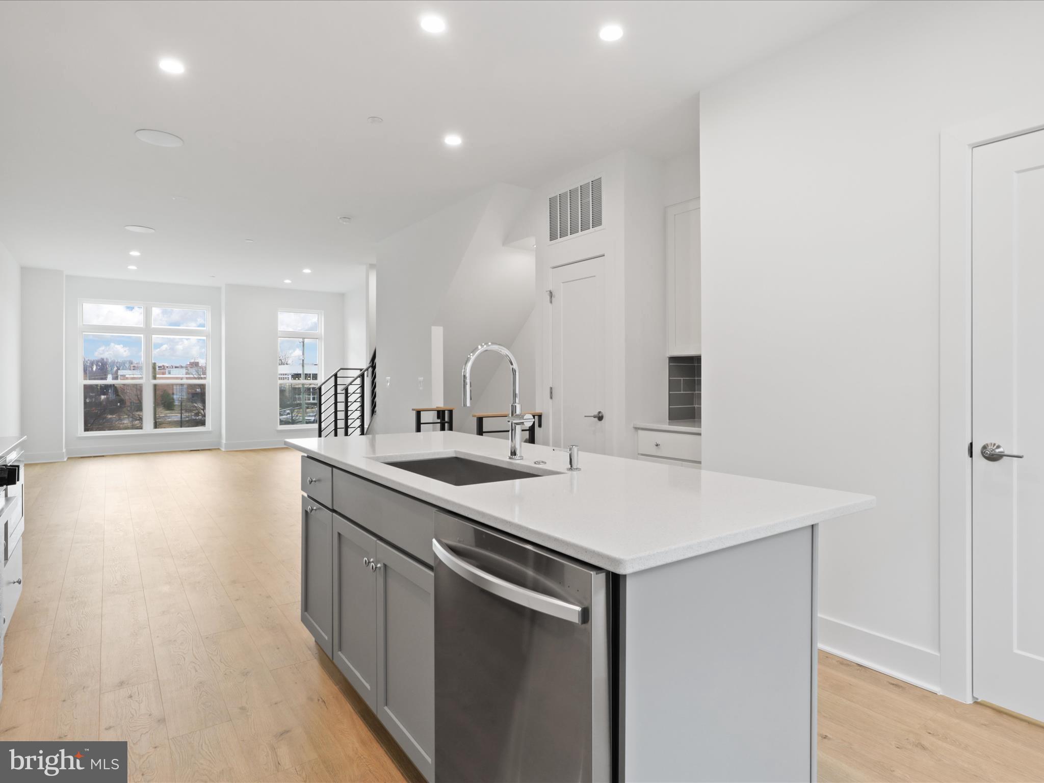2064 Tysons Ridgeline Road Falls Church, VA 22043 - Photo 15 of 43 a kitchen with a sink and a stove with wooden floor