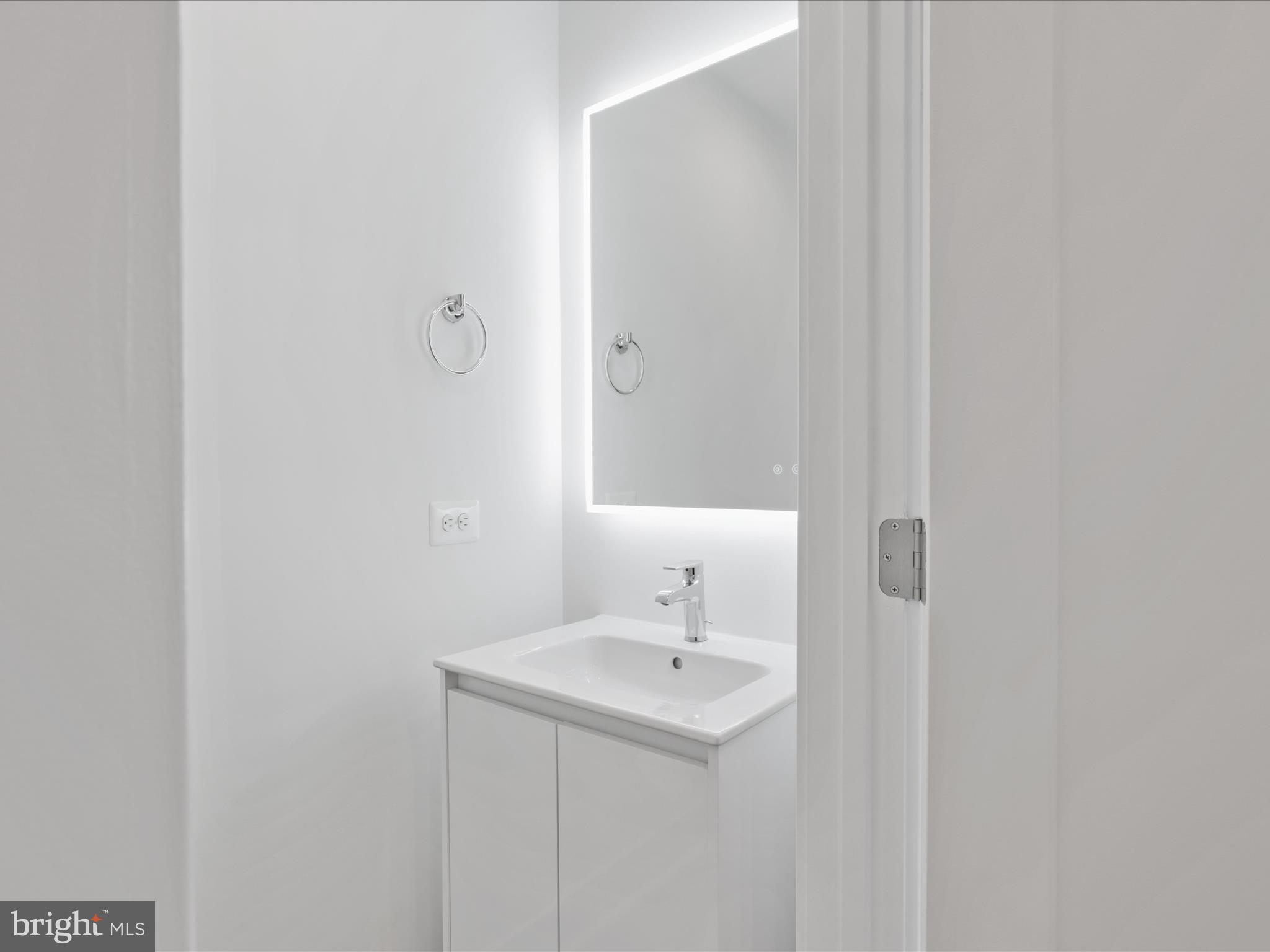 2064 Tysons Ridgeline Road Falls Church, VA 22043 - Photo 16 of 43 a bathroom with a sink a mirror and a toilet