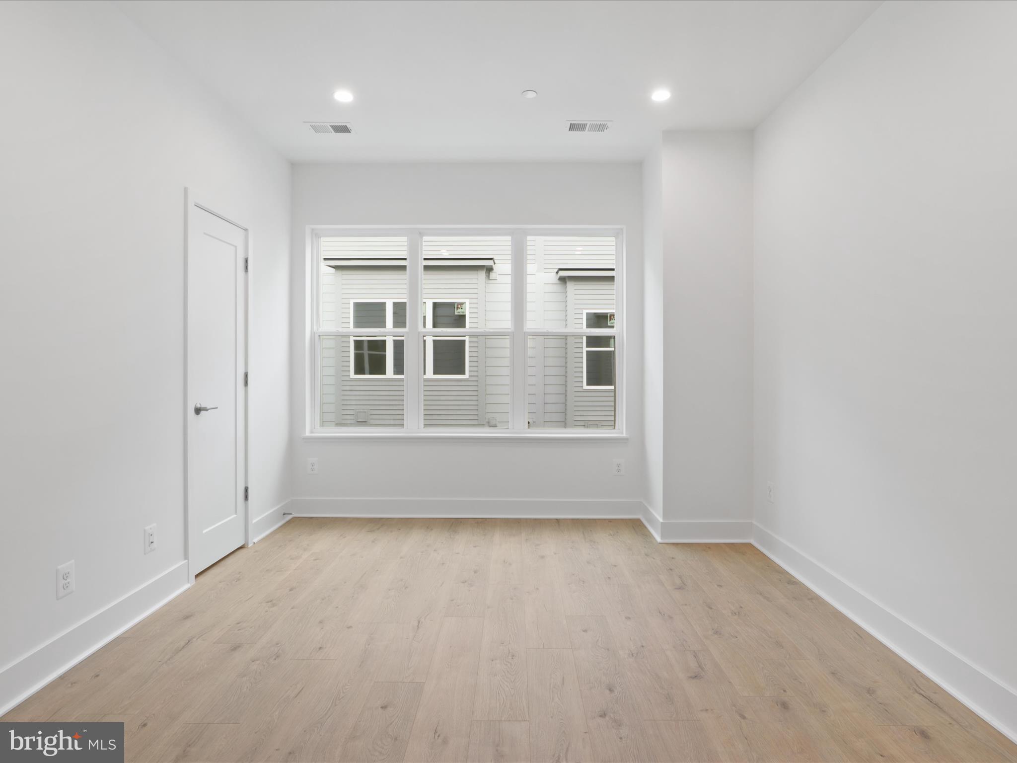 2064 Tysons Ridgeline Road Falls Church, VA 22043 - Photo 18 of 43 an empty room with wooden floor and windows
