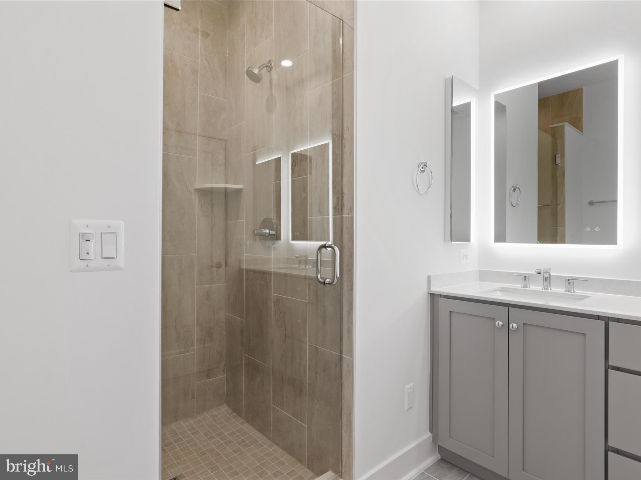2064 Tysons Ridgeline Road Falls Church, VA 22043 - Photo 22 of 43 a bathroom with a granite countertop shower sink and mirror