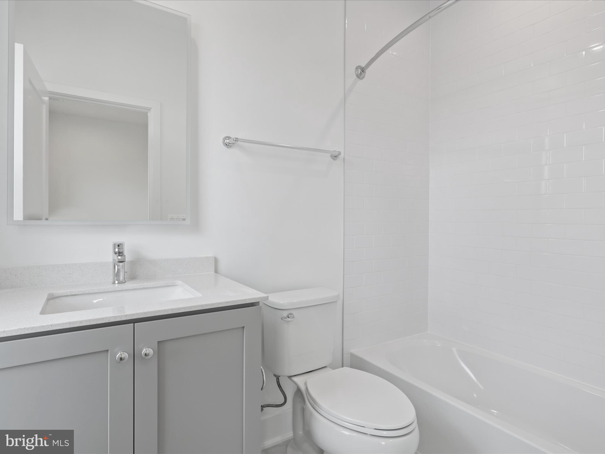 2064 Tysons Ridgeline Road Falls Church, VA 22043 - Photo 26 of 43 a bathroom with a sink toilet vanity and tub