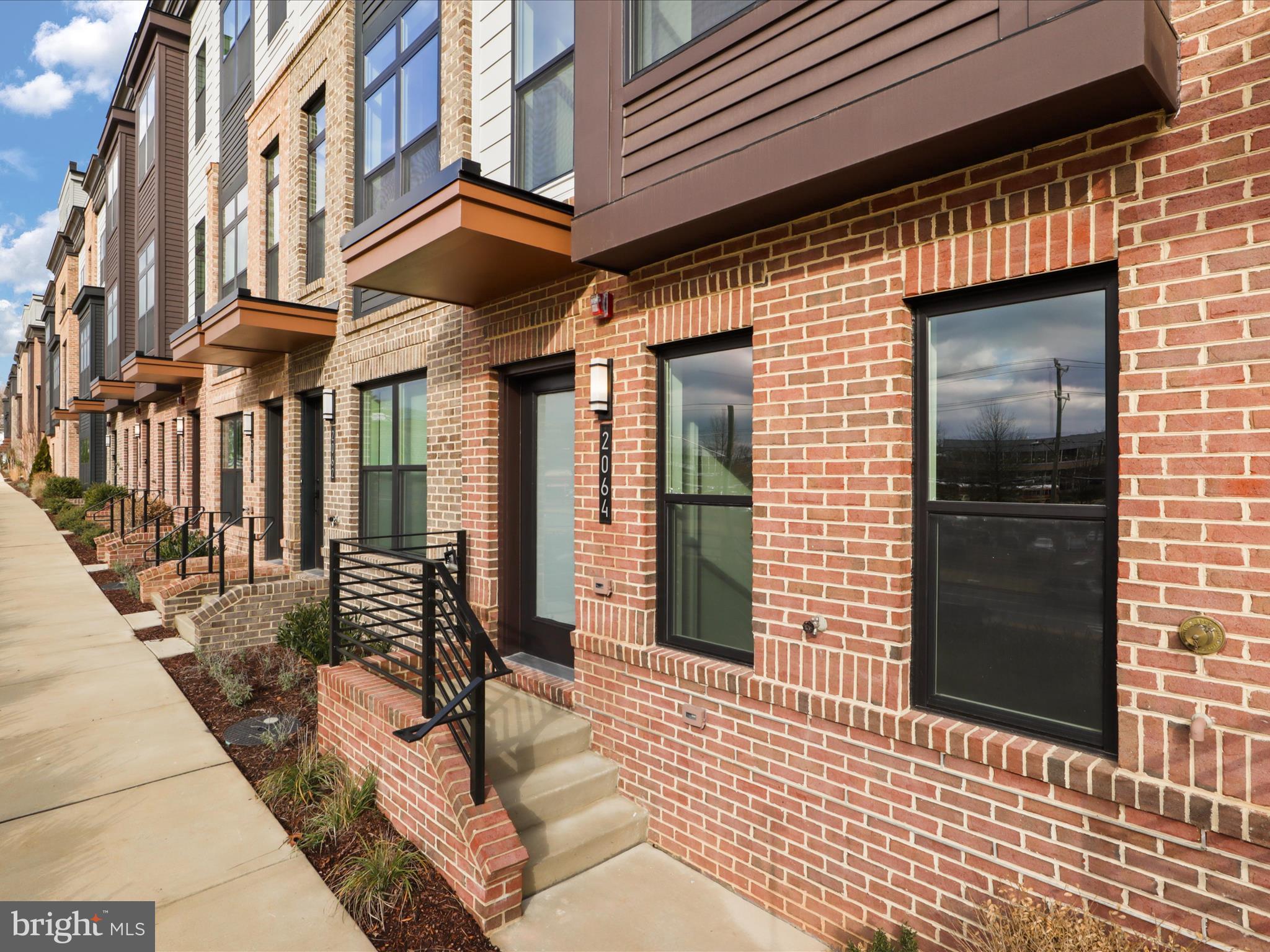 2064 Tysons Ridgeline Road Falls Church, VA 22043 - Photo 4 of 43 a view of a brick building with many windows