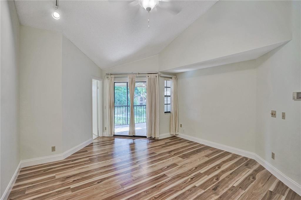 6698 Montego Bay Boulevard, Unit D Boca Raton, FL 33433 - Photo 15 of 44 wooden floor in an empty room with a window