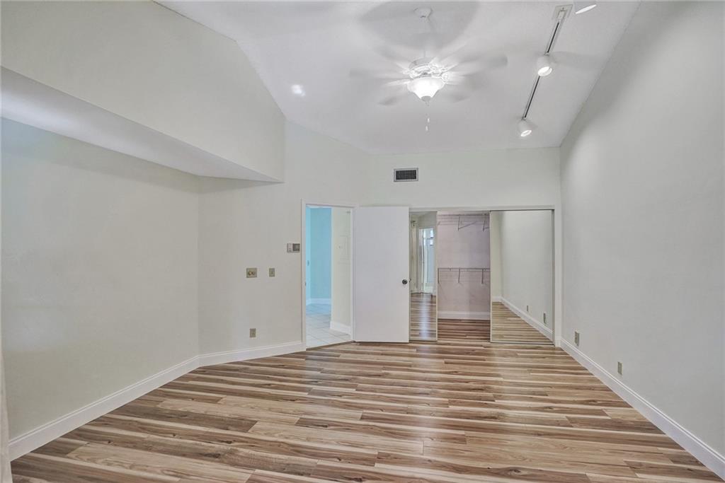 6698 Montego Bay Boulevard, Unit D Boca Raton, FL 33433 - Photo 21 of 44 a view of empty room with wooden floor