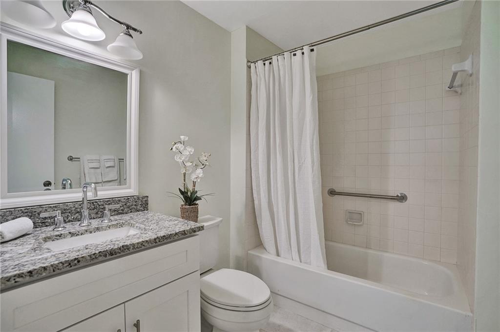 6698 Montego Bay Boulevard, Unit D Boca Raton, FL 33433 - Photo 26 of 44 a bathroom with a granite countertop sink toilet and shower