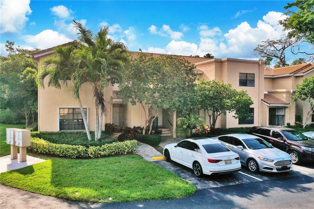 6698 Montego Bay Boulevard, Unit D Boca Raton, FL 33433 - Photo 31 of 44 a front view of a house with garden