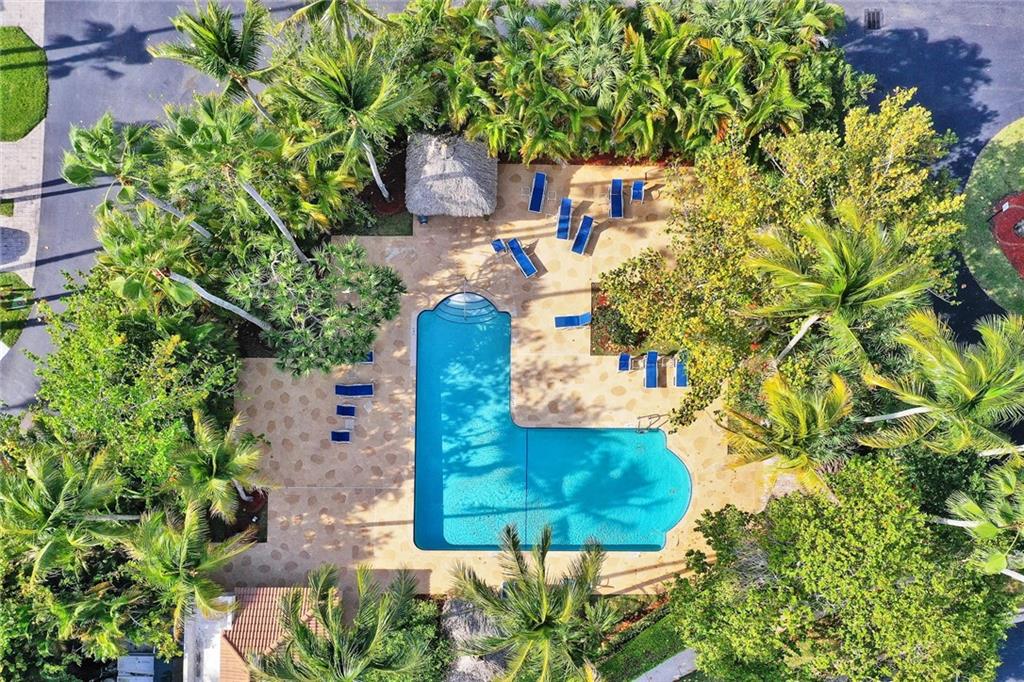 6698 Montego Bay Boulevard, Unit D Boca Raton, FL 33433 - Photo 33 of 44 an aerial view of a house with a yard and large trees
