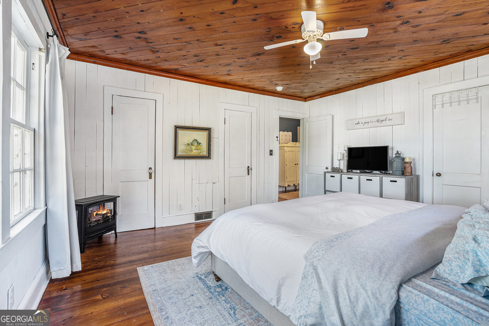 17 West Wright Street Winder, GA 30680 - Photo 17 of 31 a spacious bedroom with a bed and a flat screen tv