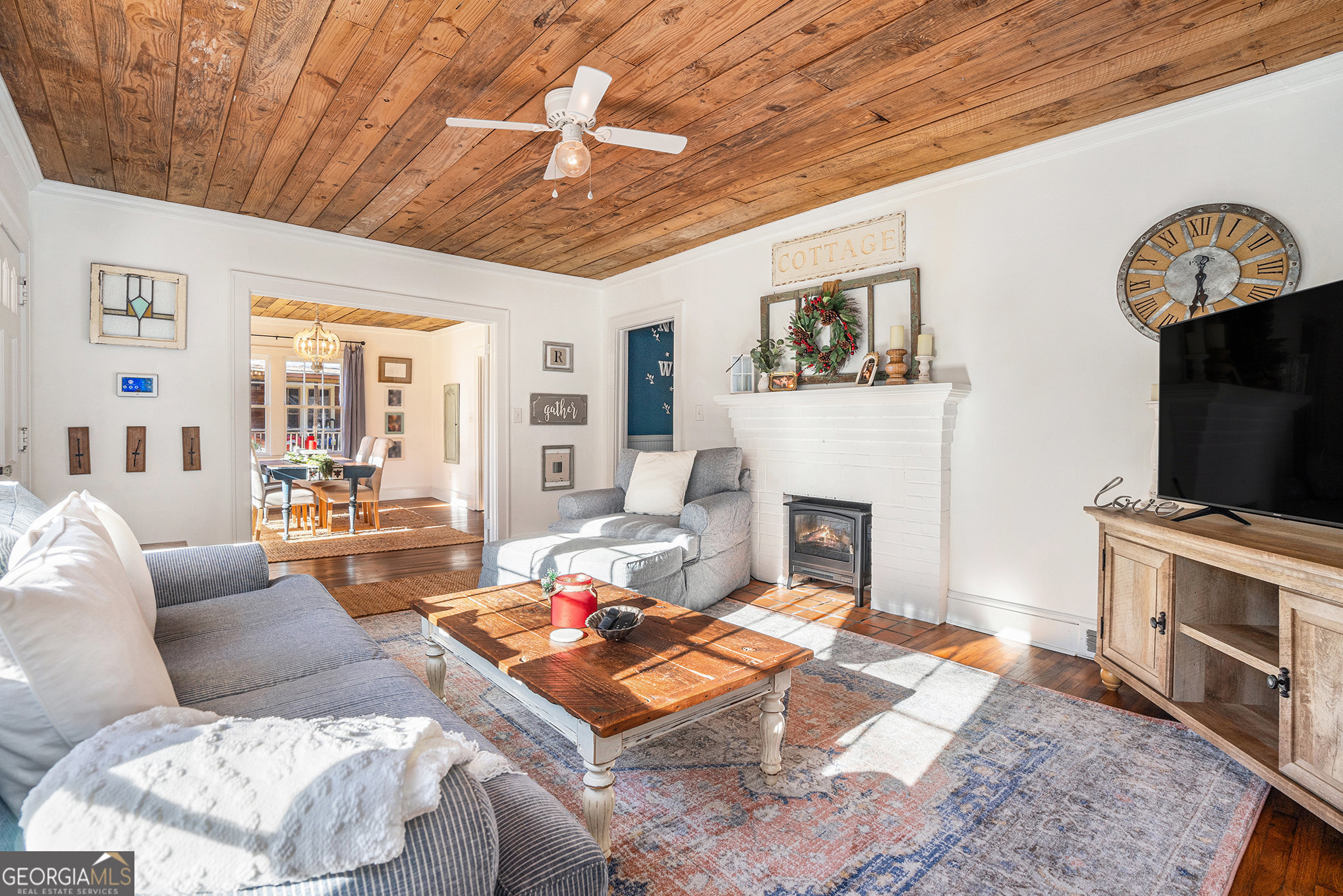 17 West Wright Street Winder, GA 30680 - Photo 7 of 31 a living room with furniture a flat screen tv and a fireplace