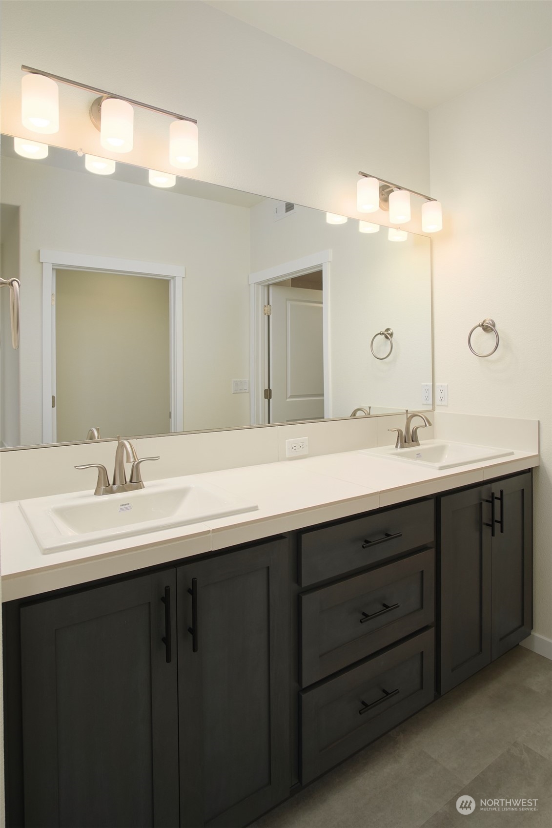 1080 Rw Fletcher Street Winlock, WA 98596 - Photo 19 of 27 a bathroom with a double vanity sink and mirror
