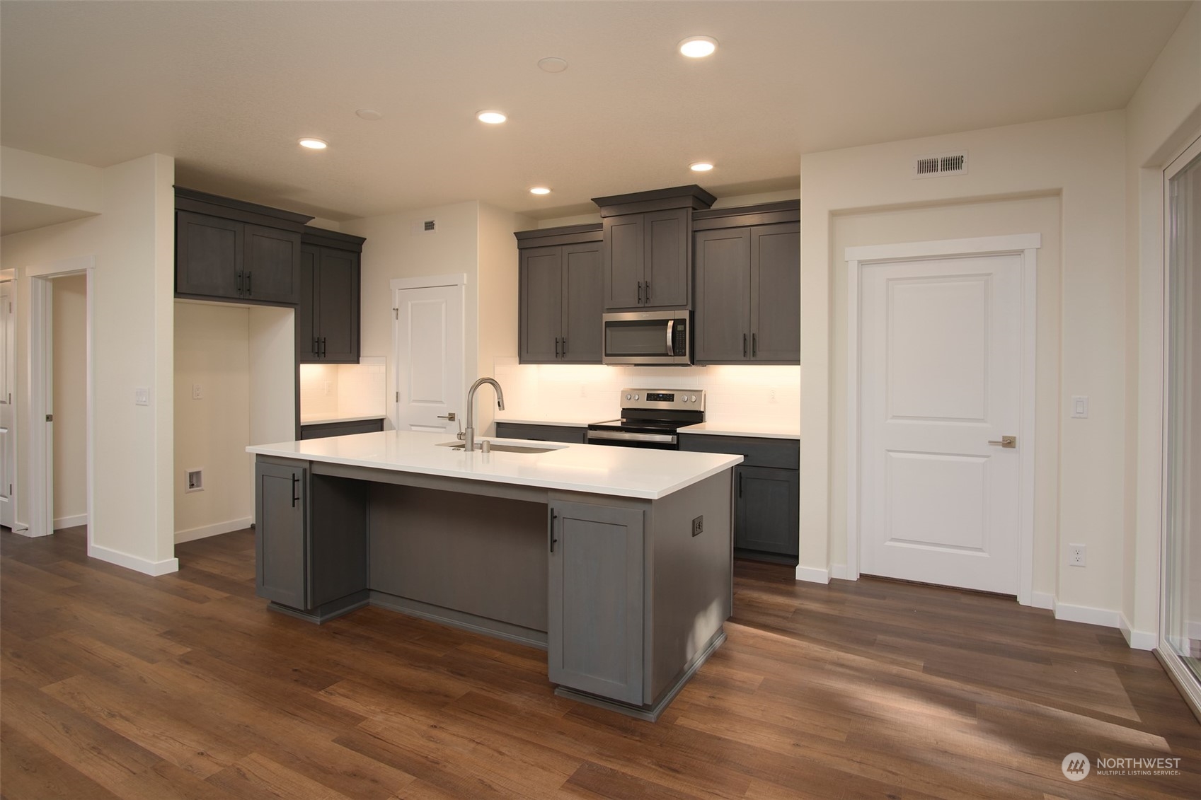 1080 Rw Fletcher Street Winlock, WA 98596 - Photo 21 of 27 a kitchen with stainless steel appliances granite countertop a sink stove and refrigerator