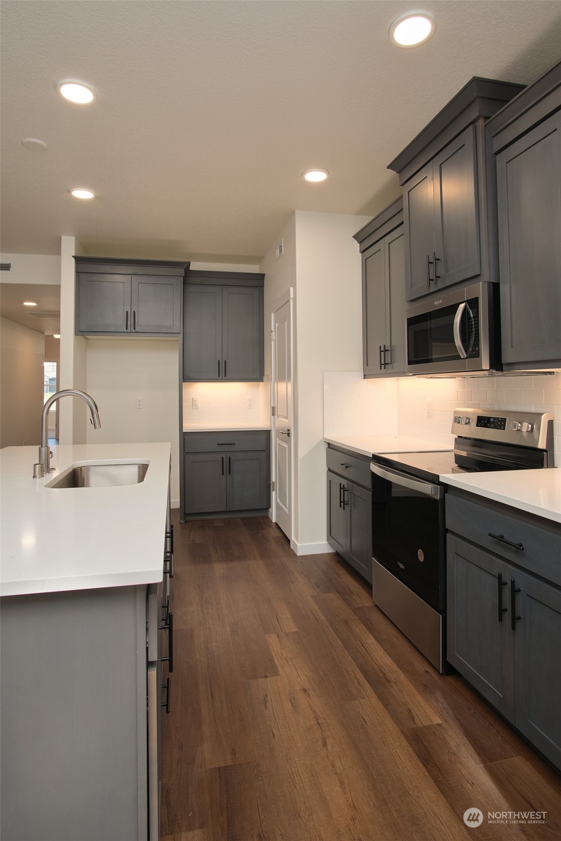 1080 Rw Fletcher Street Winlock, WA 98596 - Photo 22 of 27 a kitchen with stainless steel appliances a sink stove and refrigerator
