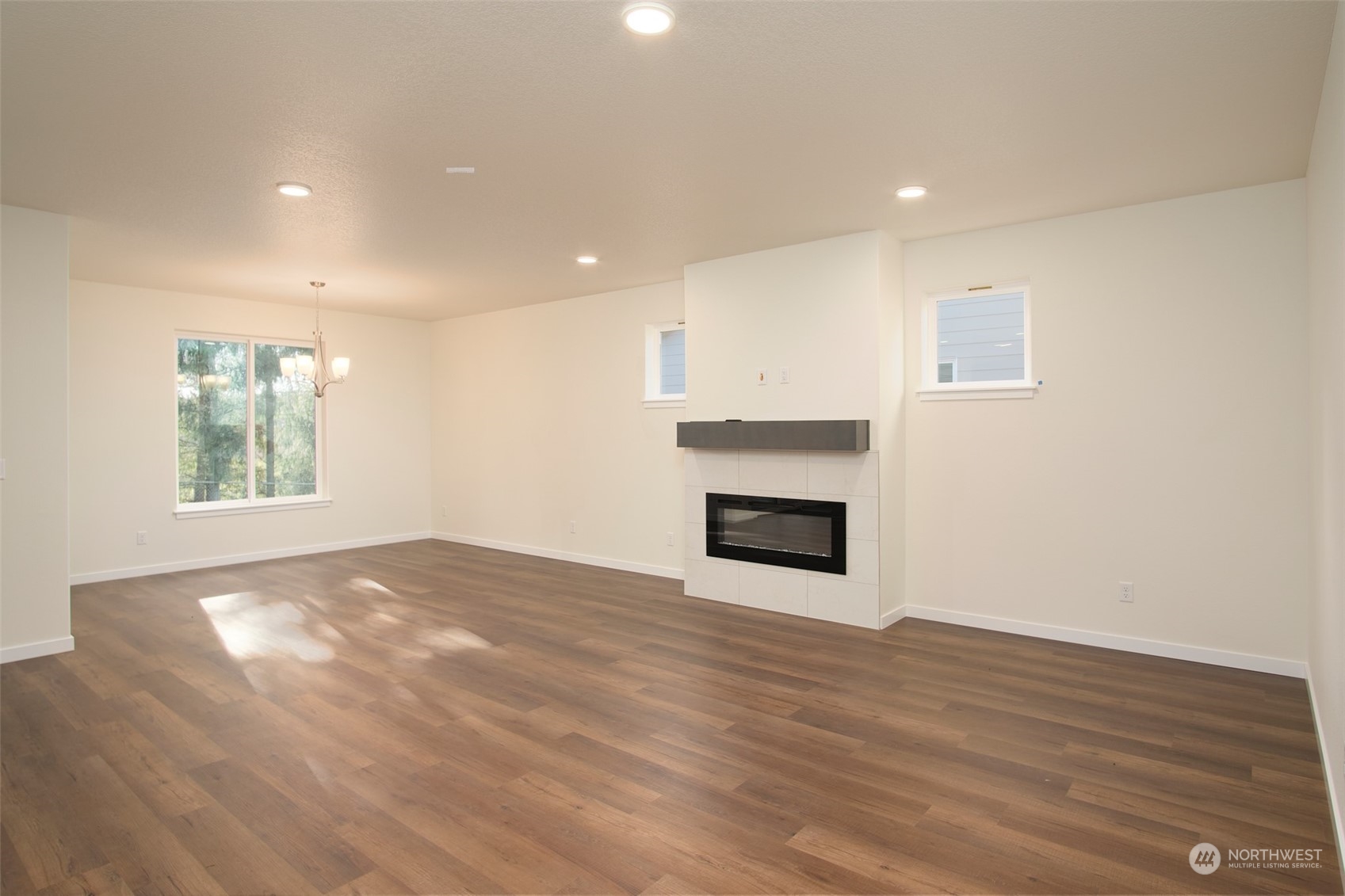 1080 Rw Fletcher Street Winlock, WA 98596 - Photo 24 of 27 a view of empty room with wooden floor and fireplace