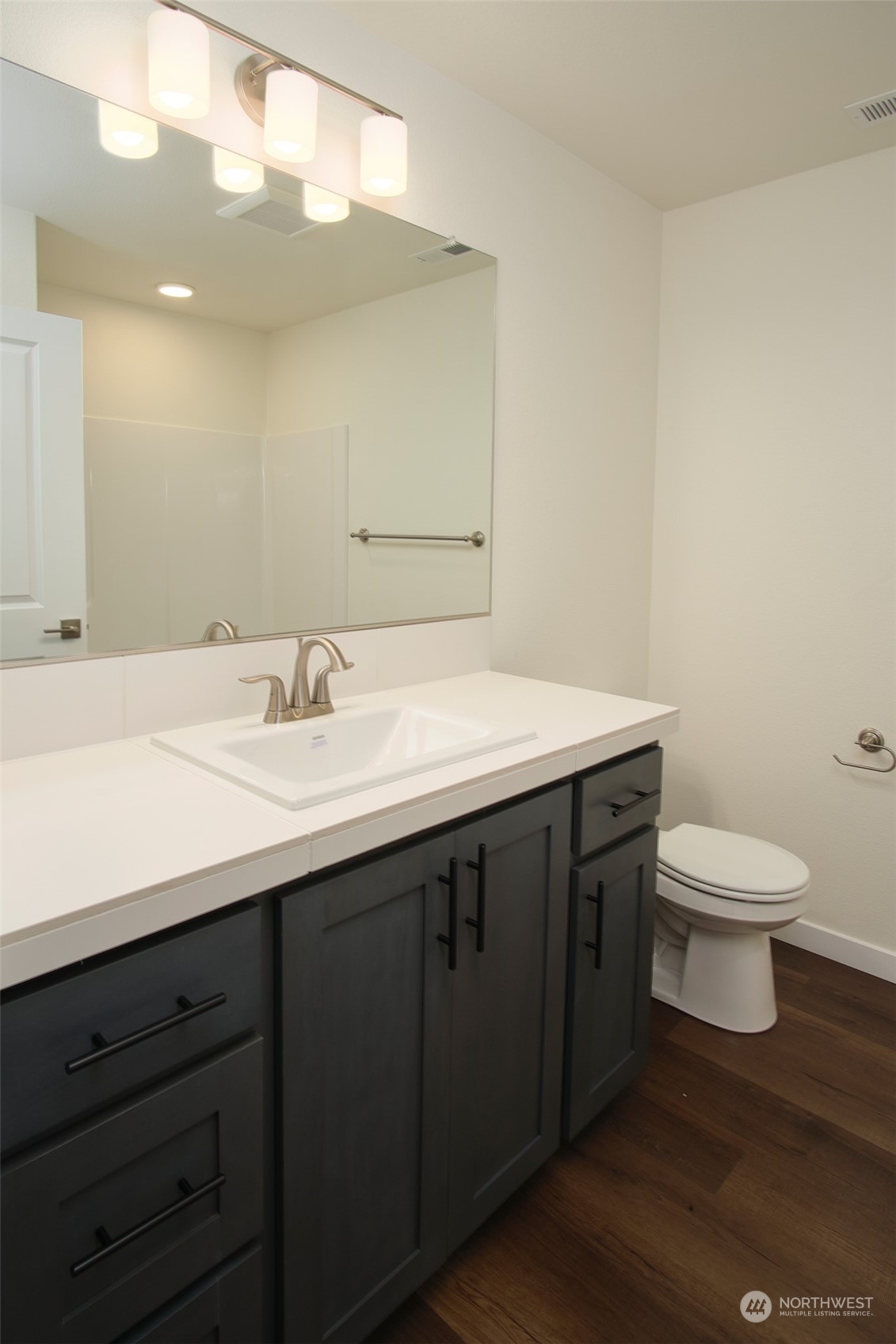 1080 Rw Fletcher Street Winlock, WA 98596 - Photo 7 of 27 a bathroom with a sink a toilet and a mirror
