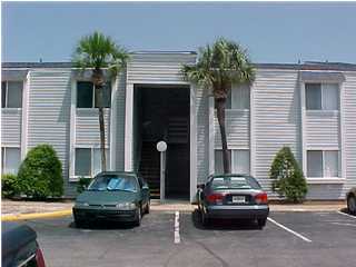 a car parked in front of house with a small yard