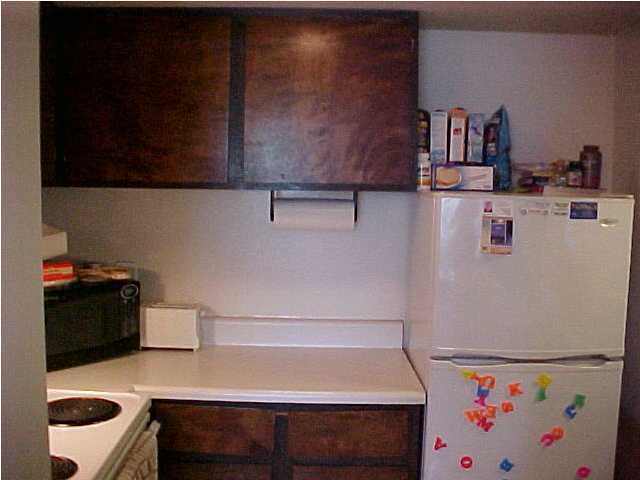 101 Old Ferry Road, Unit 18C Shalimar, FL 32579 - Photo 6 of 9 a kitchen with a refrigerator and cabinets