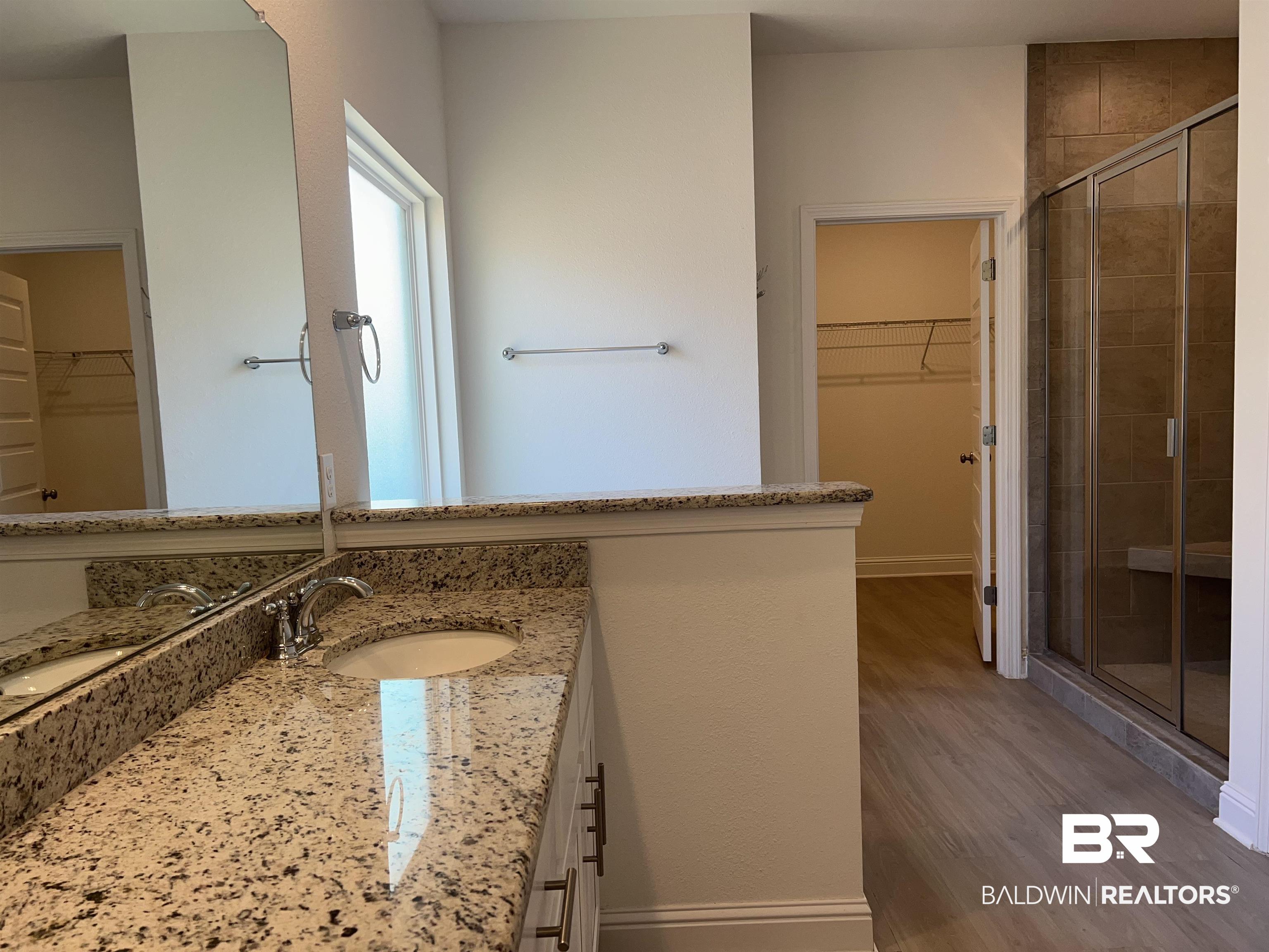 8855 Calverton Street Foley, AL 36535 - Photo 51 of 76 Bathroom with hardwood / wood-style floors, vanity, and a shower with shower door
