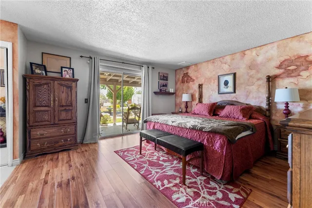 a bed room with a bed and a painting on the wall