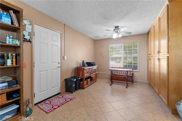a view of a patio with table and chairs under an umbrella