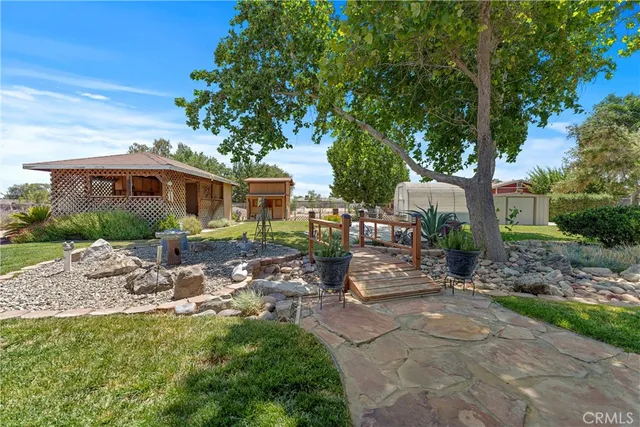 a view of a house with backyard sitting area and garden