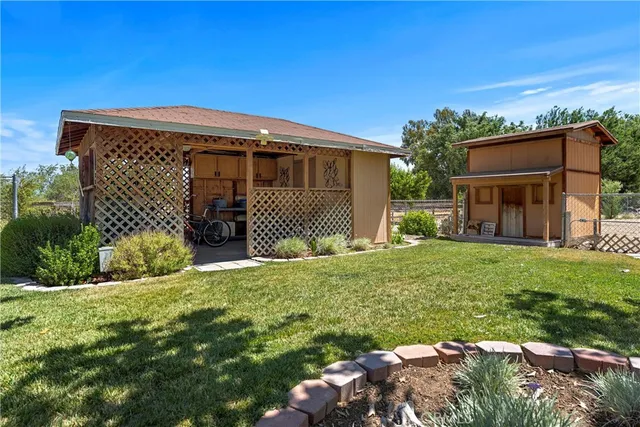 a view of a house with a yard patio and sitting area