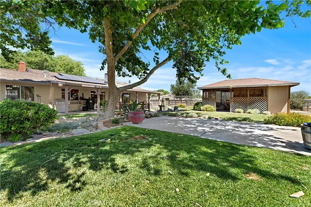 a view of house with garden and car parked