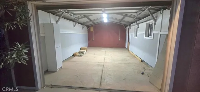 an aerial view of residential houses with outdoor space and parking