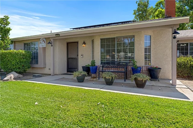 a view of a house with backyard porch and sitting area