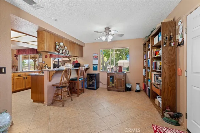 a bedroom with a bed lamp and a large window