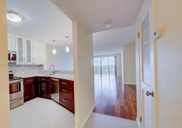 a large kitchen with stainless steel appliances granite countertop a stove and a sink