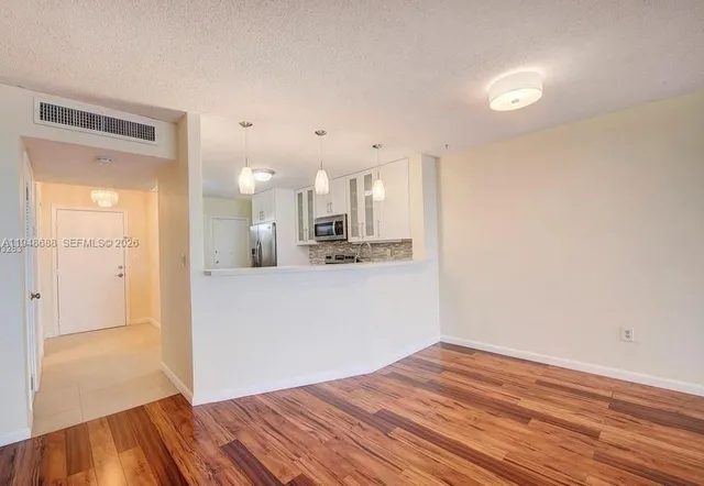 a view of a kitchen with wooden floor