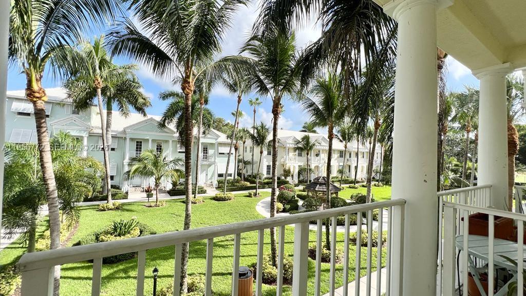 1475 Scilly Cay Lane, Unit 1475 Jupiter, FL 33458 - Photo 16 of 29 a view of a yard with a fountain and a palm tree