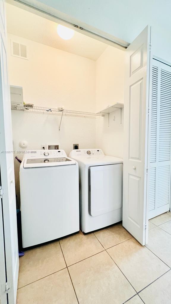 1475 Scilly Cay Lane, Unit 1475 Jupiter, FL 33458 - Photo 22 of 29 a utility room with dryer and washer