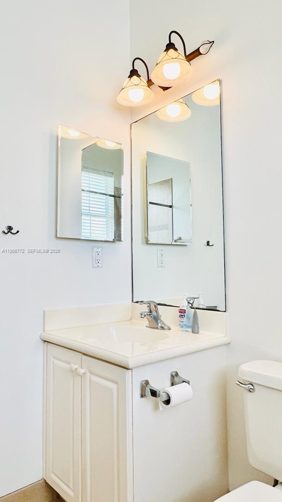 1475 Scilly Cay Lane, Unit 1475 Jupiter, FL 33458 - Photo 23 of 29 a bathroom with a sink vanity and mirror