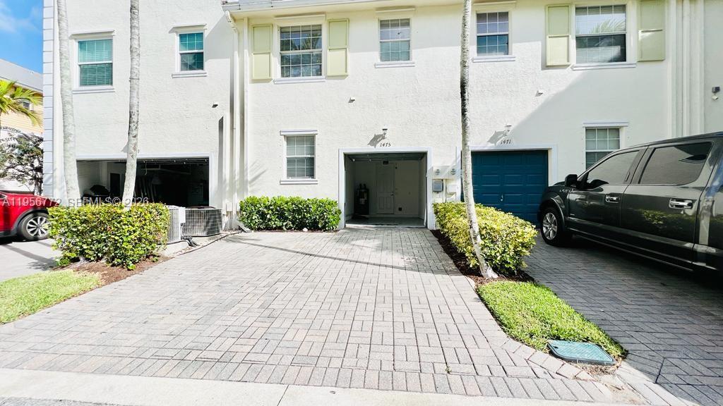 1475 Scilly Cay Lane, Unit 1475 Jupiter, FL 33458 - Photo 28 of 29 a front view of a house with a garden