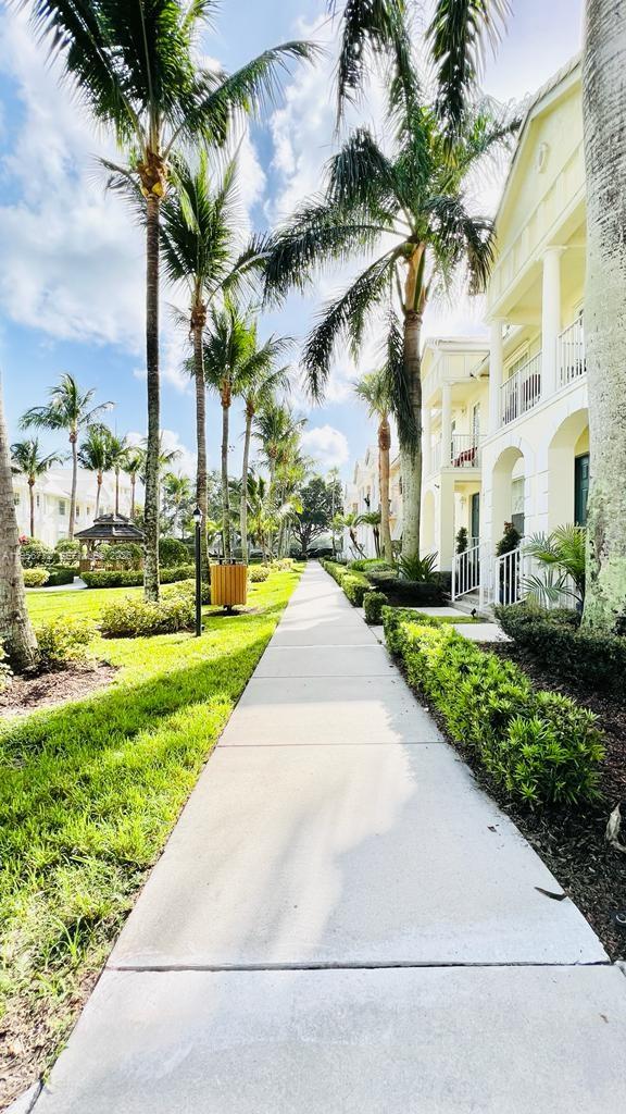 1475 Scilly Cay Lane, Unit 1475 Jupiter, FL 33458 - Photo 3 of 29 a view of a park with a fountain plants and palm trees