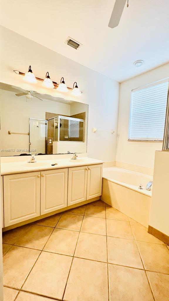 1475 Scilly Cay Lane, Unit 1475 Jupiter, FL 33458 - Photo 10 of 29 a bathroom with a granite countertop sink mirror and bathtub