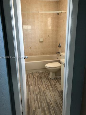 a bathroom with a granite countertop shower toilet and a sink