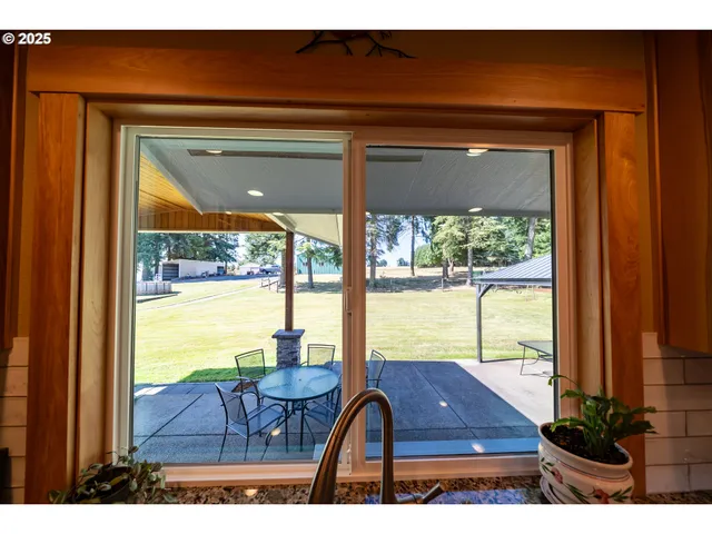 a view of a porch with furniture and floor to ceiling window