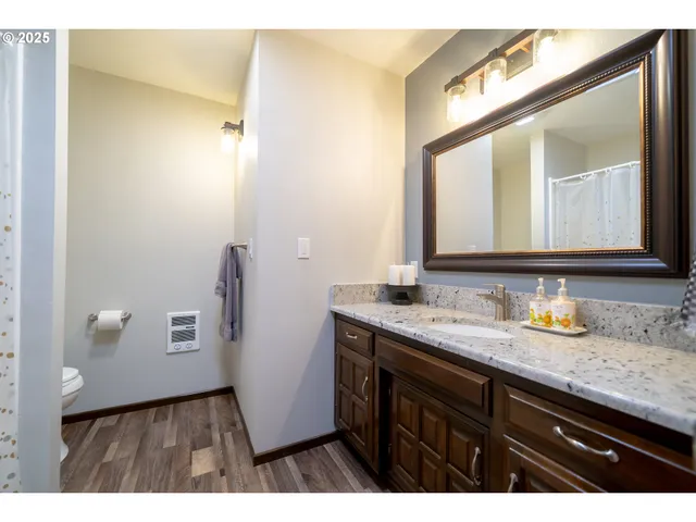 a bathroom with a granite countertop sink a mirror and a