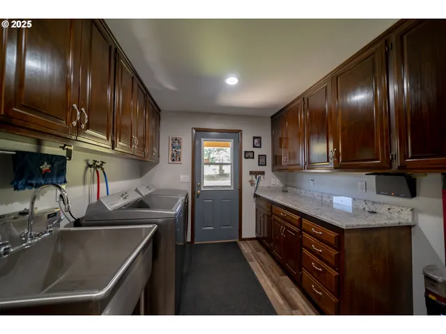 a kitchen with stainless steel appliances granite countertop a sink stove and cabinets