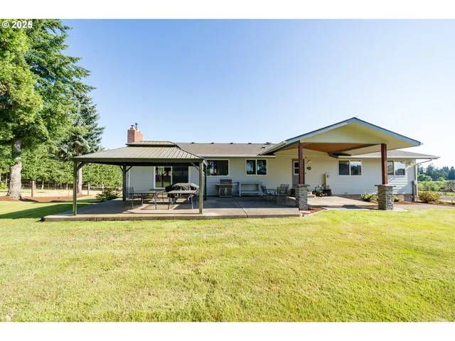 a view of a house with swimming pool and sitting area