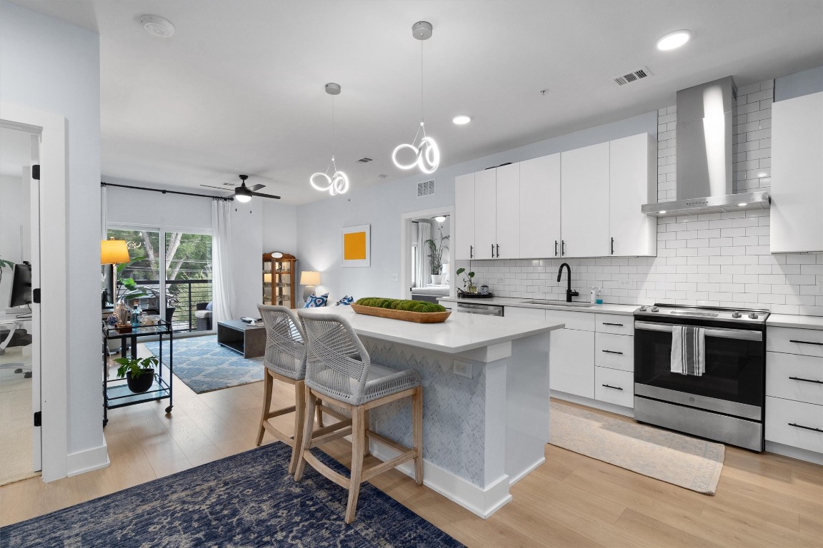 3101 Govalle Avenue, Unit 201 Austin, TX 78702 - Photo 1 of 1 a kitchen with stainless steel appliances granite countertop a stove oven and a refrigerator with cabinets