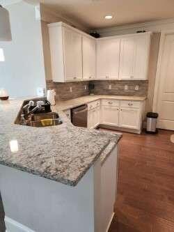 194 Yorkshire Lane Villa Rica, GA 30180 - Photo 6 of 20 a kitchen with granite countertop a sink a stove and cabinets