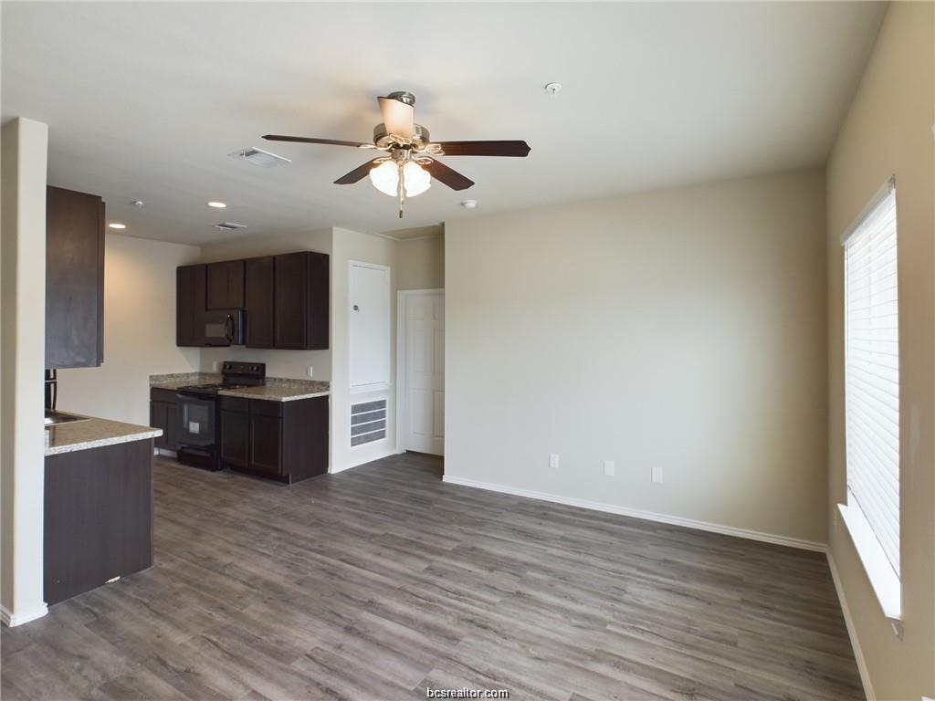 2910 Town Square Avenue, Unit 2604 Bryan, TX 77802 - Photo 3 of 8 a view of kitchen with sink microwave and refrigerator