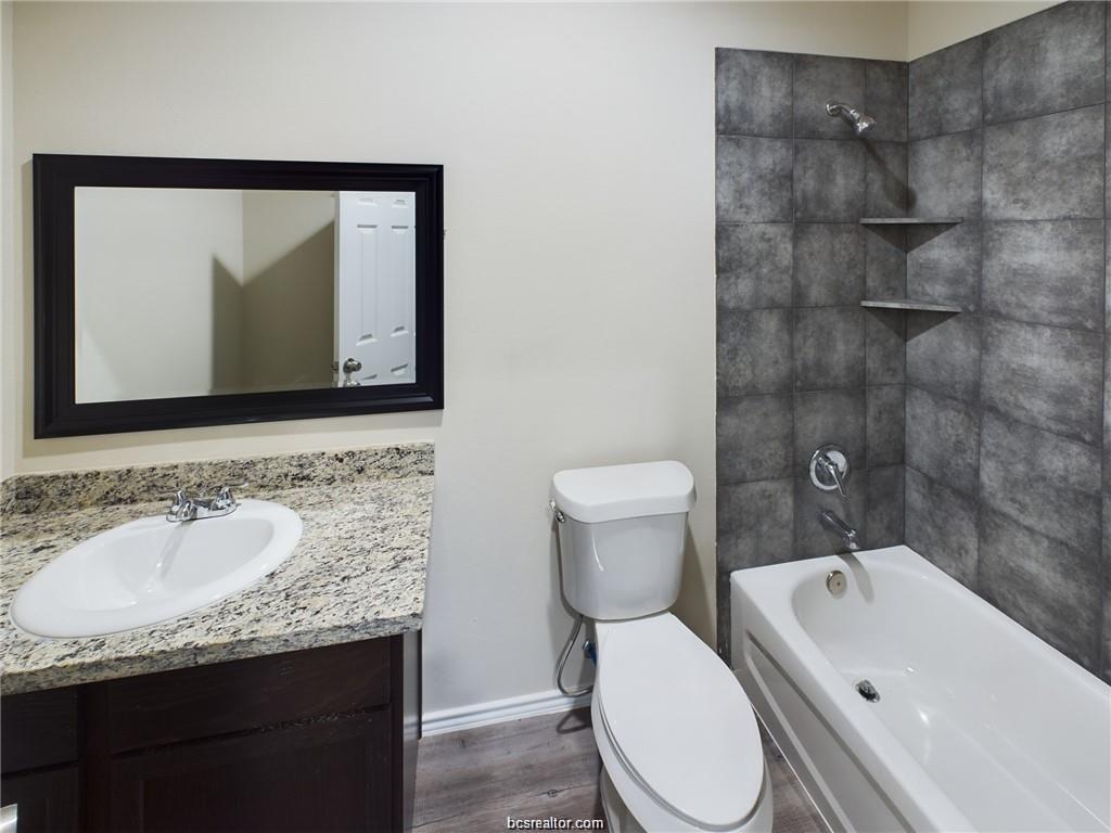 2910 Town Square Avenue, Unit 2604 Bryan, TX 77802 - Photo 7 of 8 a bathroom with a toilet sink and mirror