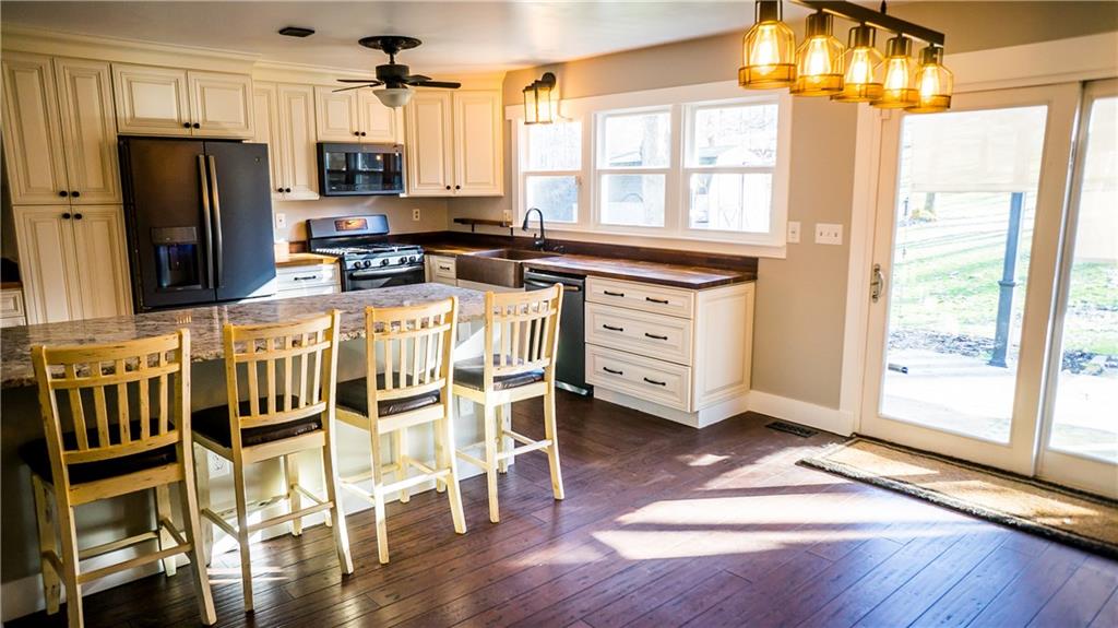 450 Leslie Road Valencia, PA 16059 - Photo 3 of 25 An updated kitchen features a ton of cabinet and counter space with granite island, butcher block counter tops, and pantry closet.