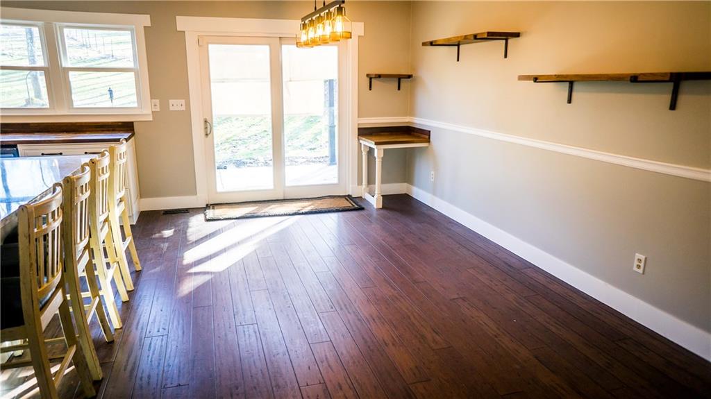450 Leslie Road Valencia, PA 16059 - Photo 6 of 25 Easy-care flooring has been installed. The sliding doors lead out to a deck and back-yard.
